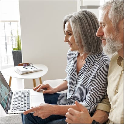 A senior couple conduct virtual visit with a physician via their desktop device